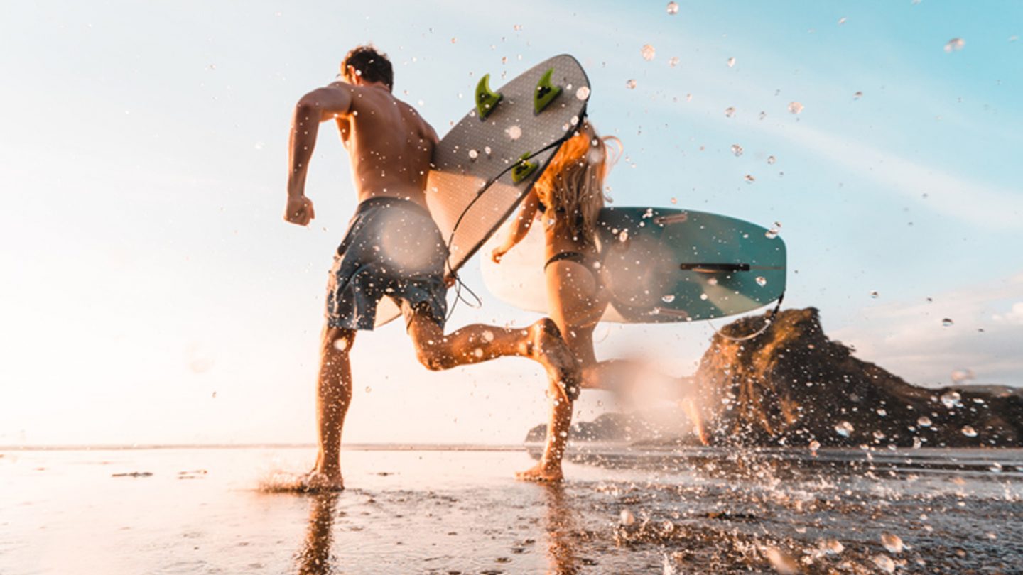 Surfers arriving at Piha Beach on Auckland's wild west coast