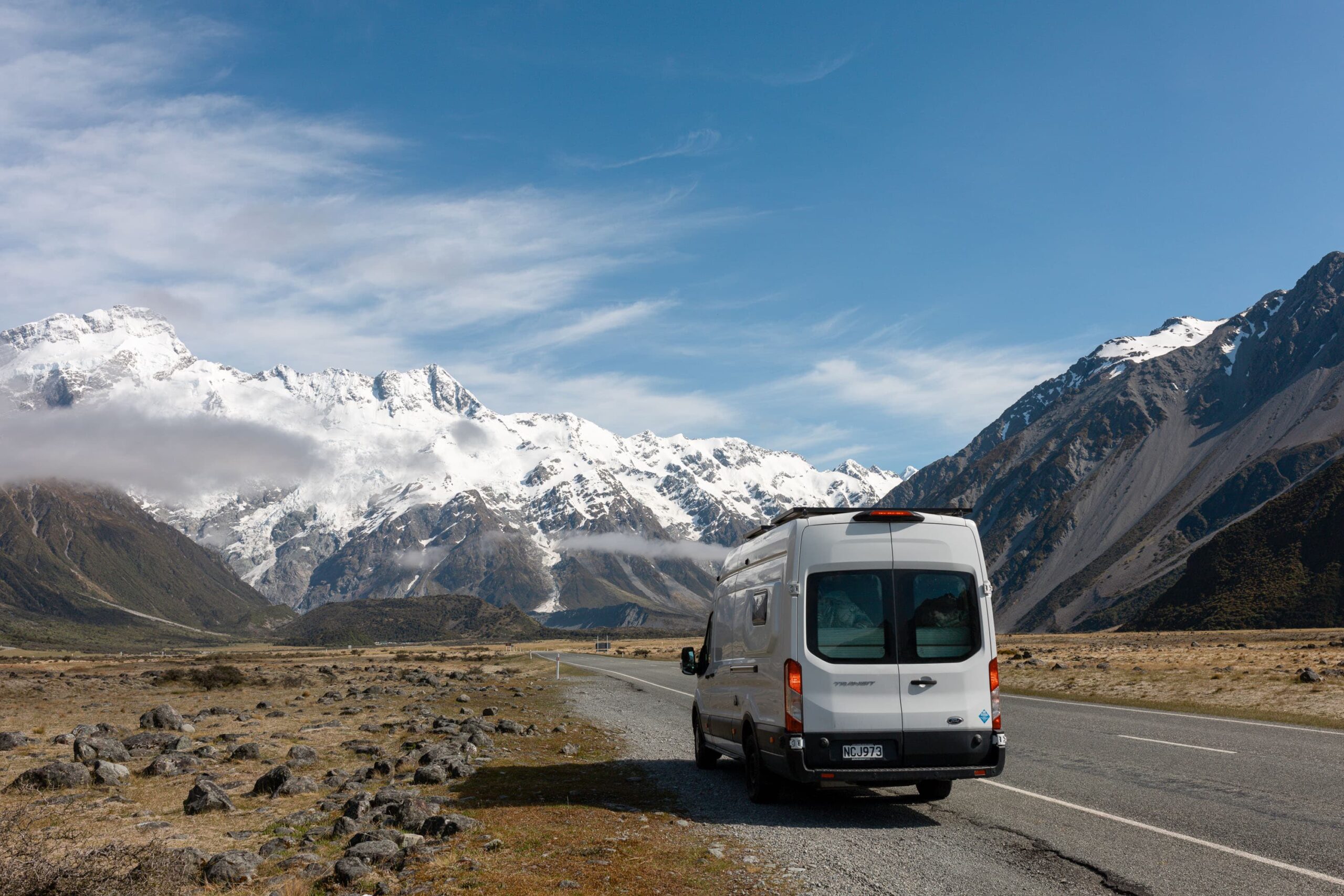 A Quirky Campers campervan named Kaewa parked in front of New Zealand mountains