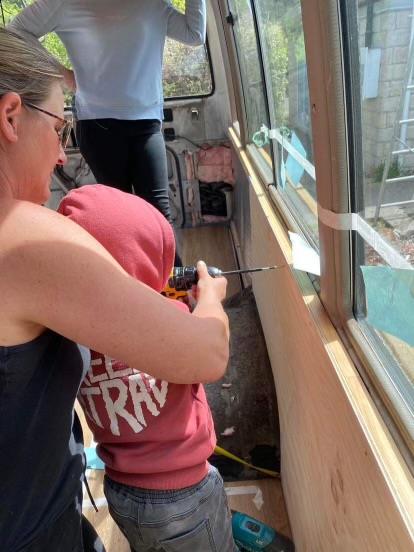 Cruzar Custom Campervans co-owner Brenda at work on a campervan conversion with another little helper from the Cruzar family