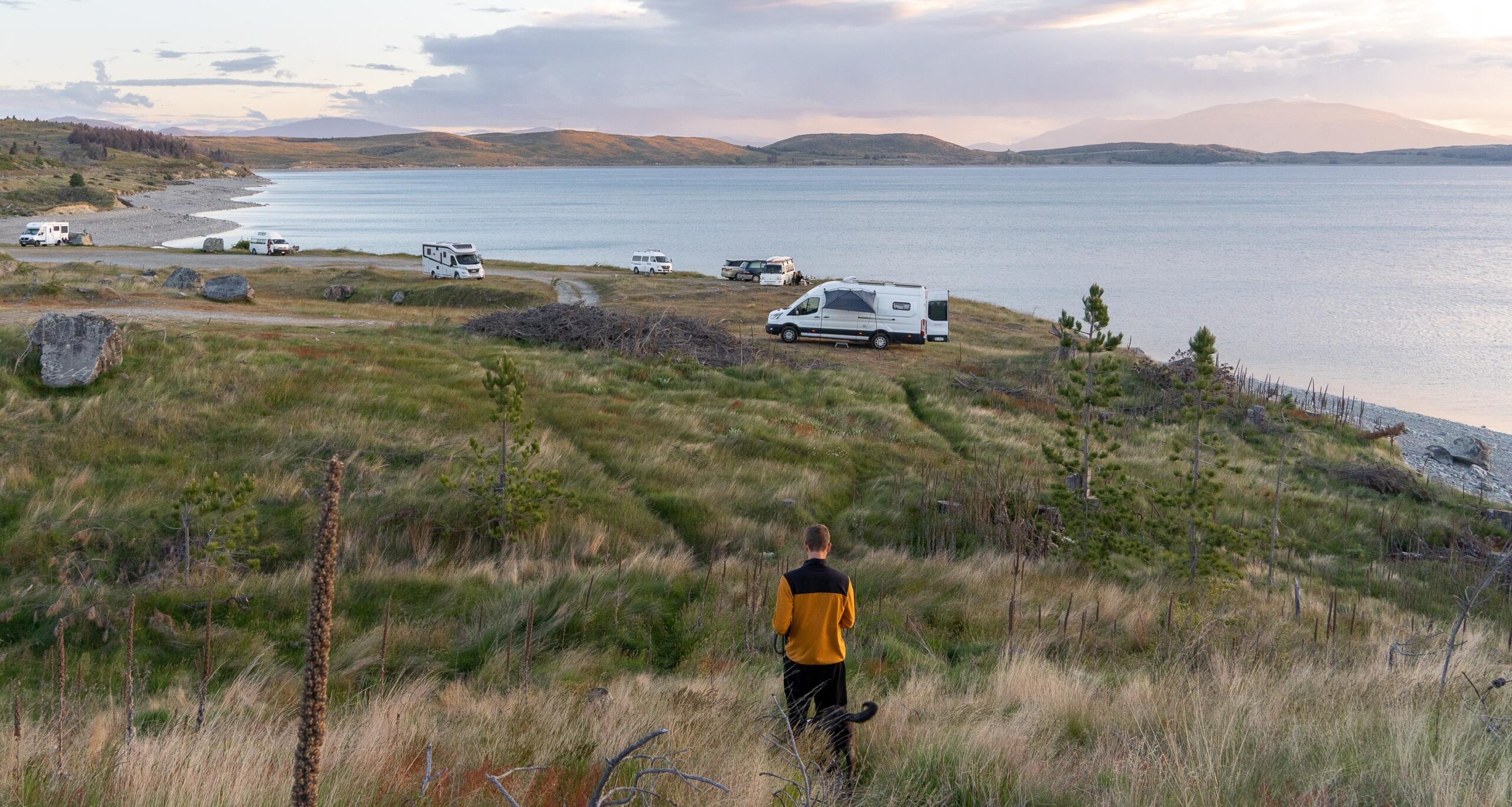 Campervans parked at a lakeside campsite in New Zealand