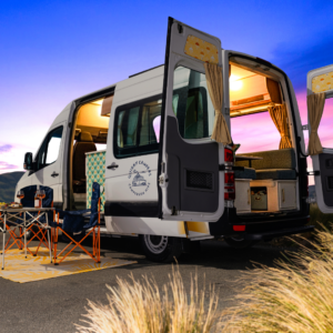 Campervan with door open and dusk skyline