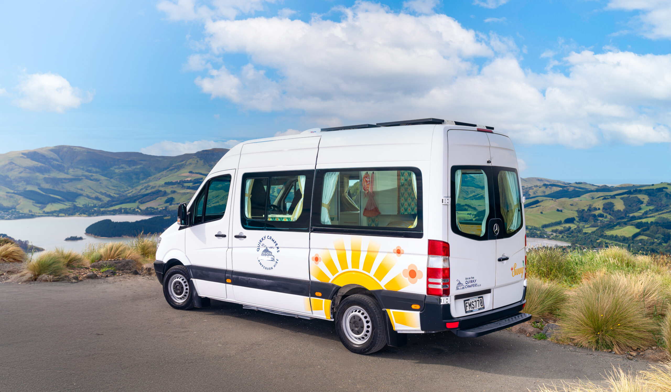 Sunny campervan parked overlooking a lake in New Zealand
