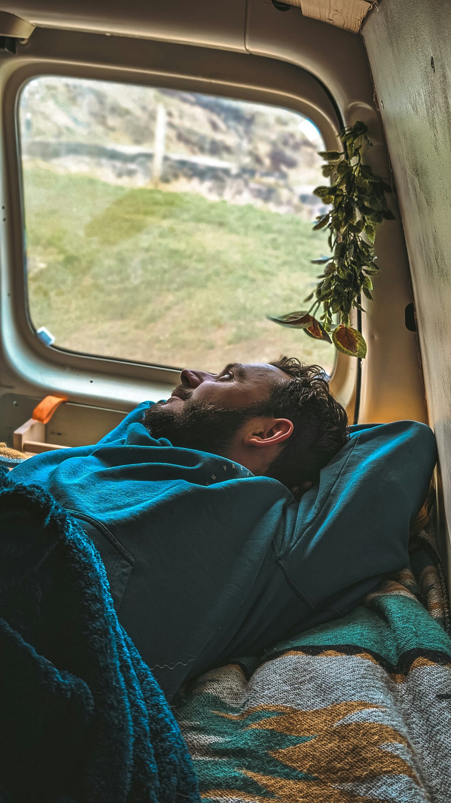 Person relaxing inside a campervan