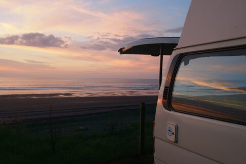 Campervan by the beach at sunset