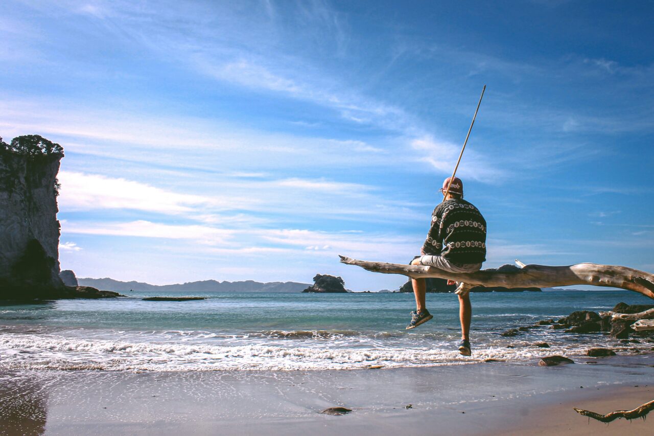 Person looking out over the bay at Cathedral Cove, New Zealand