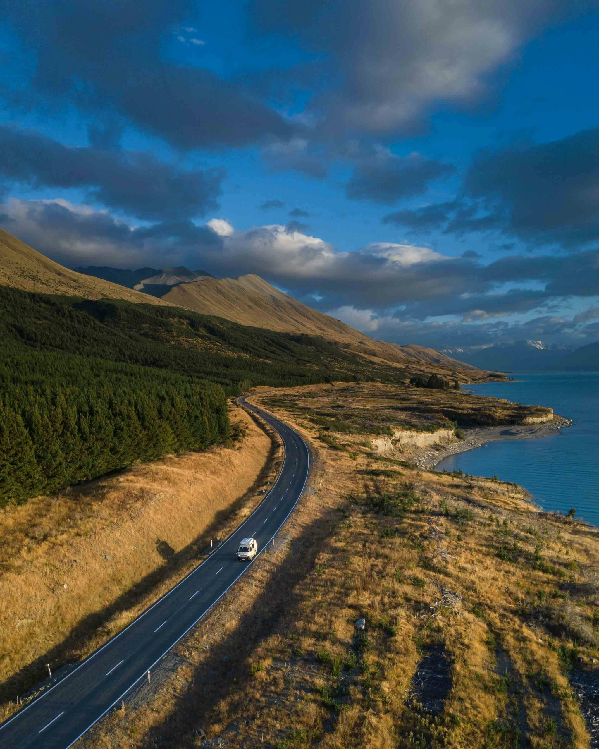 A campervan on the road through New Zealand wilderness