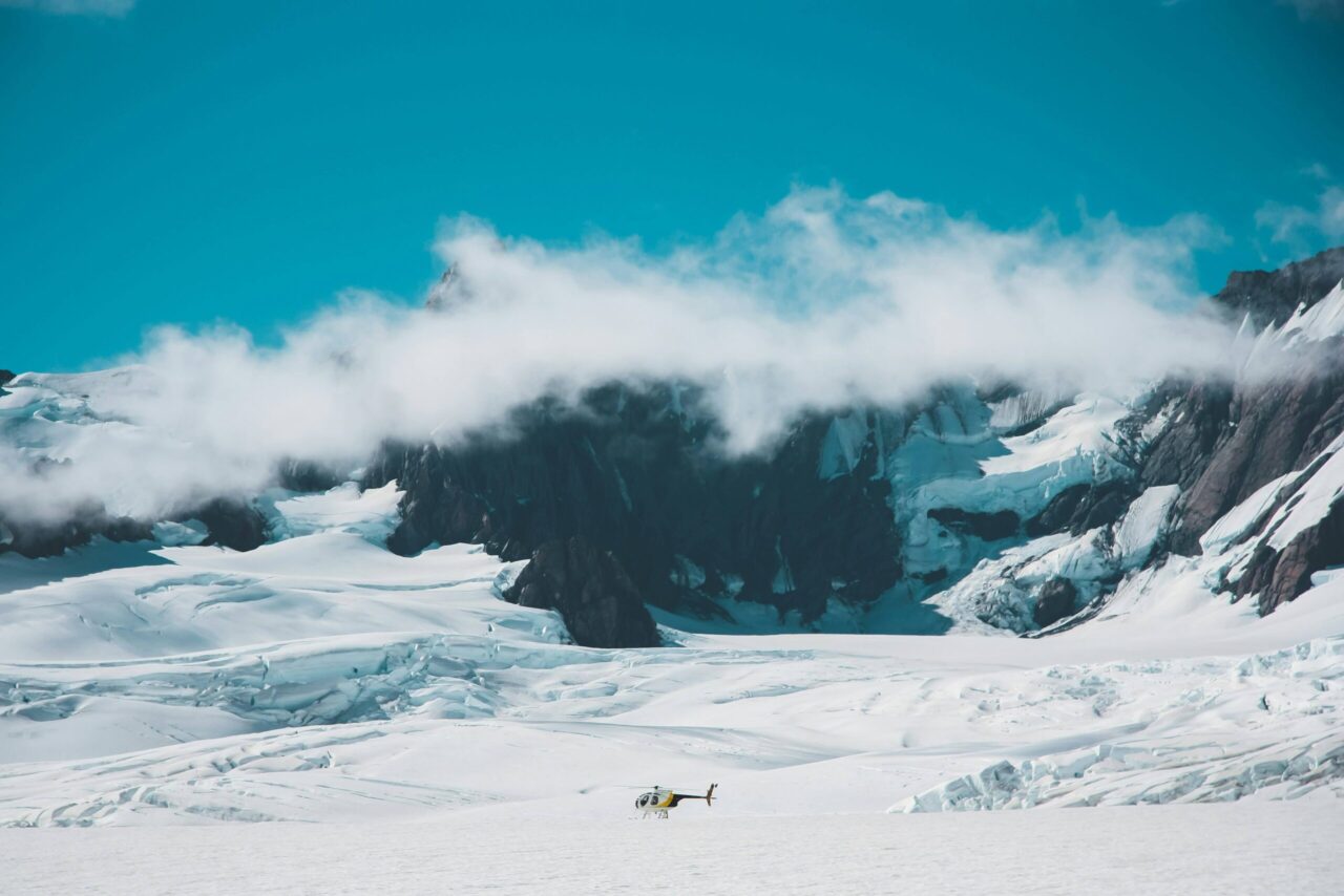Franz Josef Glacier descending between bush-covered mountains in Westland