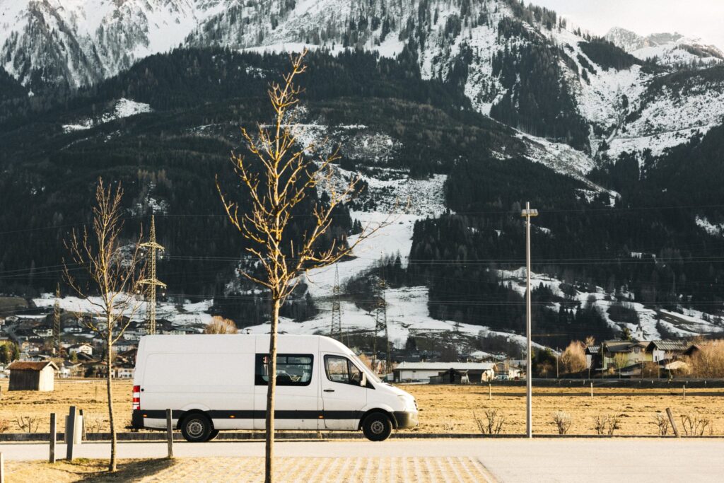 a campervan at the foot of mountains on a european tour