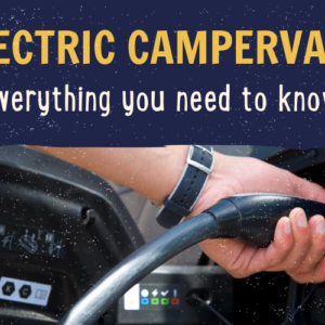 A person wearing a blue wristwatch is plugging a charging cable into an electric campervan. The top of the image features bold yellow text that reads "Electric Campervans" with white text underneath that says "everything you need to know." The background shows part of the vehicle's charging port.
