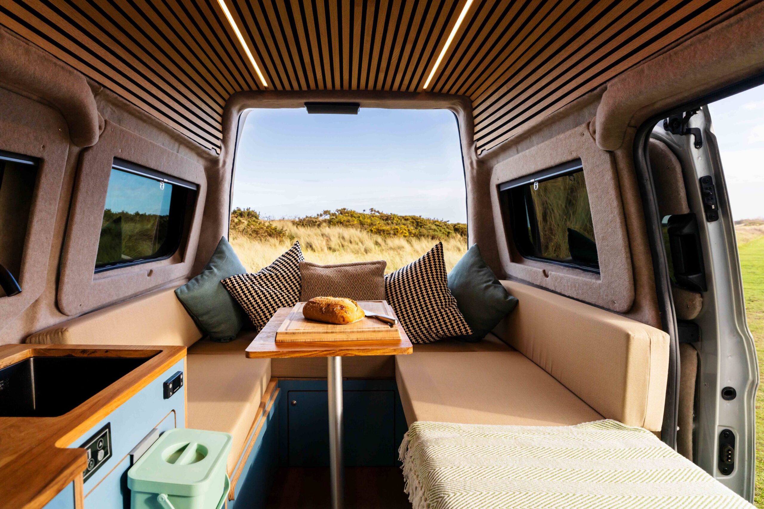 Campervan U shape seating area with rear doors open