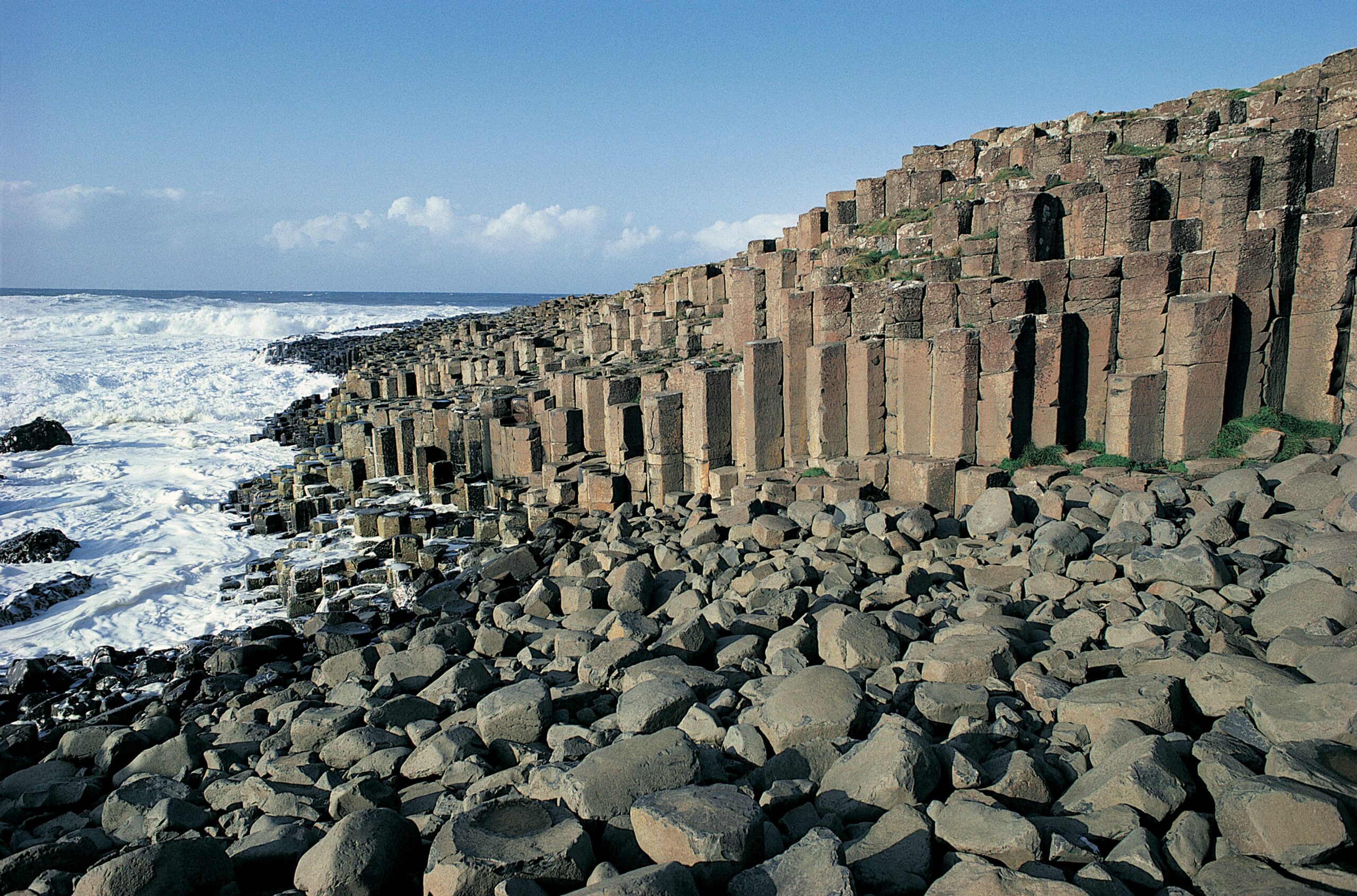 A panoramic view of the Giant's Causeway in Antrim, Northern Ireland, showcasing its unique hexagonal basalt columns.