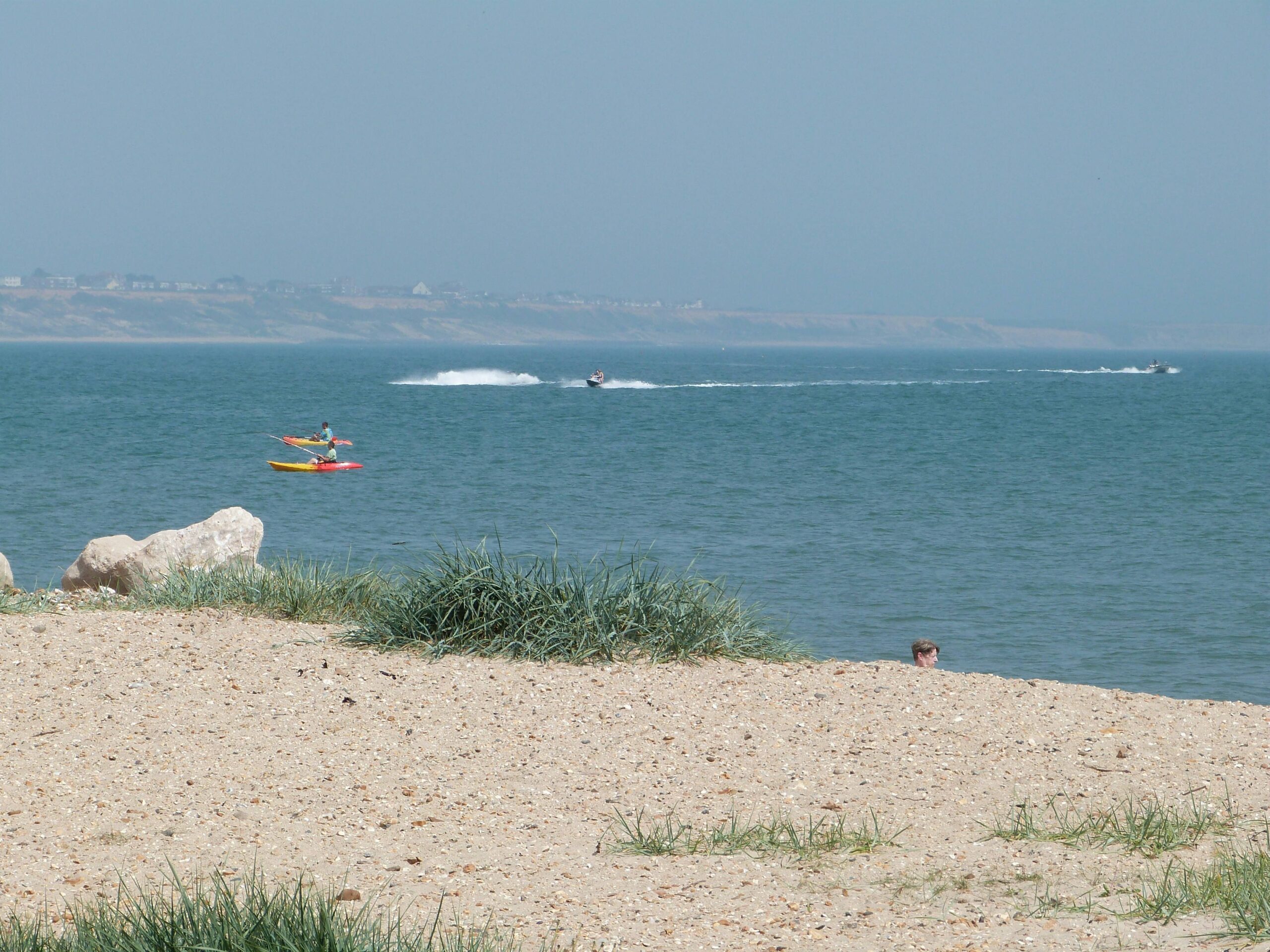 jet skis and canoes in the ocean at shell bay