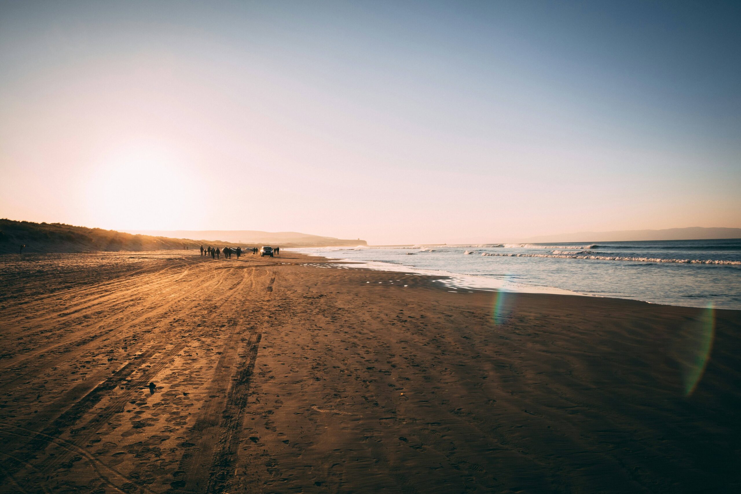A sunrise view of Portstewart Strand with the waves of the ocean to the right