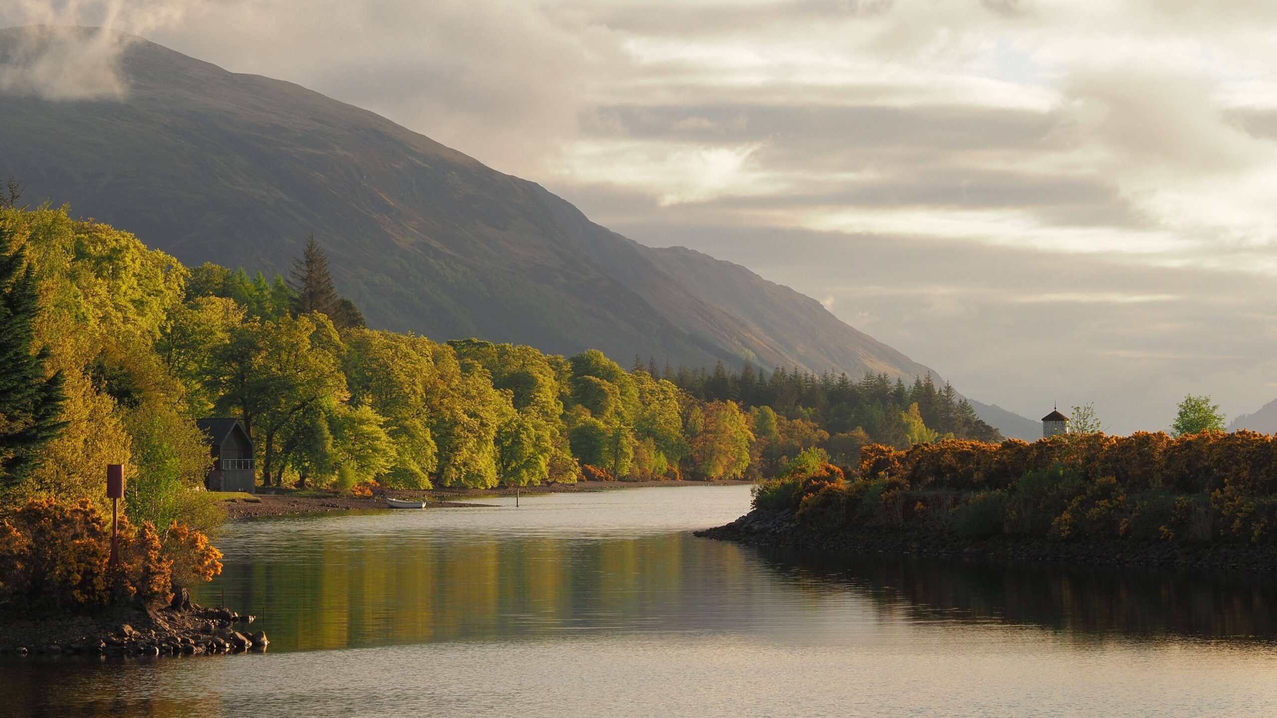A picturesque river with a boat gliding smoothly across its surface